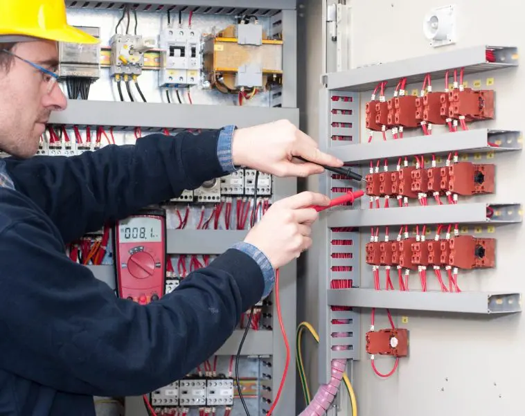 A person is working on an electrical panel.