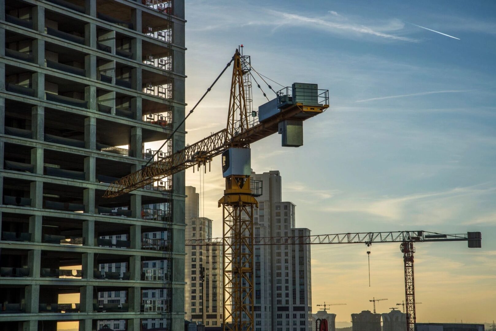 A crane is in the foreground of a building.